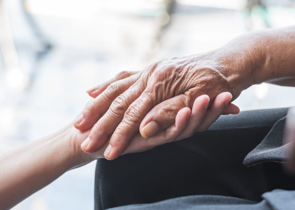 Supportive hands embracing medical decision.