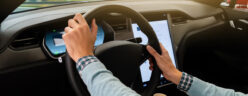 Person holds Tesla steering wheel