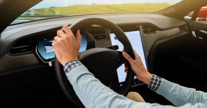 Person holds Tesla steering wheel