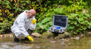 A scientist takes samples of water