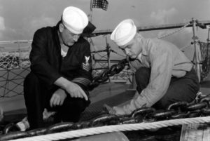 Two U.S. Navy members working on a ship