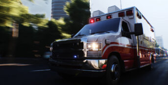 Ambulance driving down a city street with emergency lights flashing