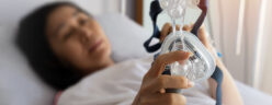 Woman holds CPAP mask